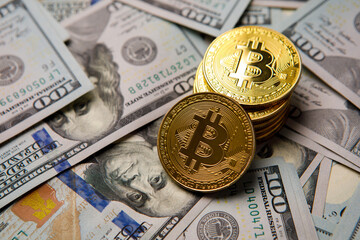golden bitcoin coin on us dollars close up. Electronic crypto currency