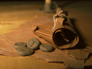 Rune stones and vintage parchment paper on warm background