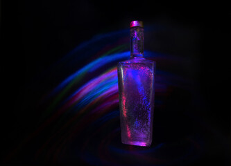 high-necked bottle illuminated by arched lines of light