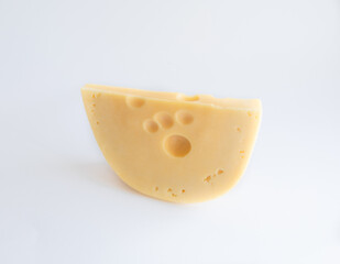 Semi Hard Cheese isolated on a white background Piece of the Medium-hard cheese with Cheese's Eyes on a light background Dairy Product Concept