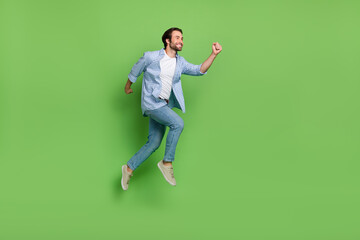 Fototapeta na wymiar Full size profile side photo of young excited guy run jump look empty space discount isolated over green color background