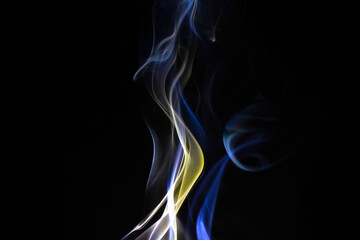 Abstract candle smoke flow on a black background. Colored fog texture photo