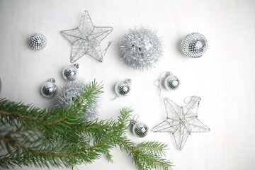 silver christmas stars and balls toys decor, fir tree branch  on white background