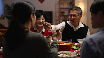 selective focus with over shoulder view smiling asian elderly couple grandfather and grandmother...