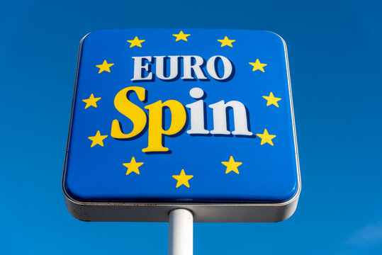Fossano, Italy - November 24, 2021: Sign of an Eurospin  italian supermarket against the blue sky. It is an Italian company in the large-scale distribution of the discount channel