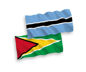 Obraz premium National vector fabric wave flags of Co-operative Republic of Guyana and Botswana isolated on white background. 1 to 2 proportion.