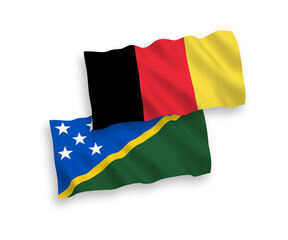 National vector fabric wave flags of Solomon Islands and Belgium isolated on white background. 1 to 2 proportion.