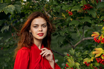 pretty woman in the summer outdoors near the bush