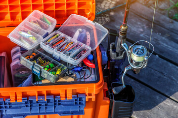 A large fisherman's tackle box fully stocked with lures and gear for fishing.fishing lures and accessories.Fishing tackle - fishing spinning. Kit of fishing lures.