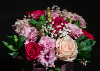 Beautiful floral bouquet on a black background. Fresh flowers in a bouquet. Close-up