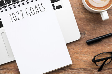 Notebook with 2022 goals text on it to apply new year resolutions and plan.