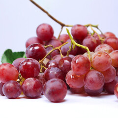 Grapes are the fruit of a woody grape vine. Grapes can be eaten raw, or used for making wine, juice, and jellyjam. Grapes come in different colours; red, purple, white. Fokus blur.