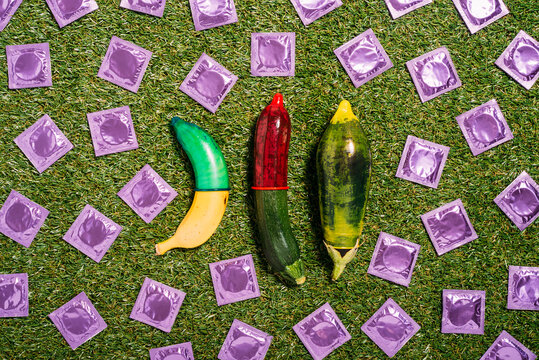 Banana and vegetables with condoms on grass