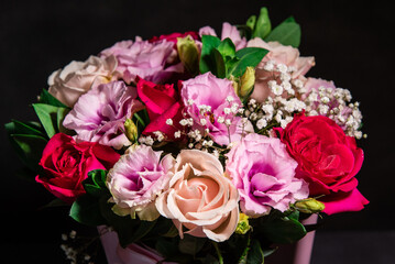 Beautiful floral bouquet on a black background. Fresh flowers in a bouquet. Close-up