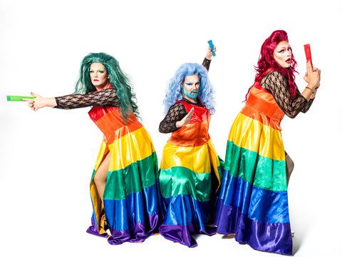 Drag queens with hand fans posing over white background