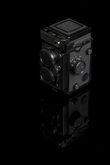 Old camera on black background