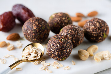 Vegan chocolate energy balls made of cashew nuts, almonds, oat flakes, dates and carob powder