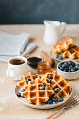 Belgian waffles with blueberries and cup of coffee