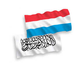 National vector fabric wave flags of Taliban and Luxembourg isolated on white background. 1 to 2 proportion.