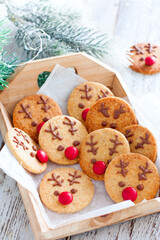 Rudolph christmas cookies with chocolate and red dragee, selective focus