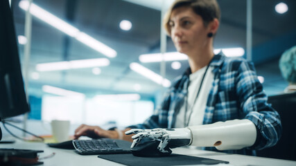 Diverse Body Positive Office: Portrait of Motivated Woman with Disability Using Prosthetic Arm to Work on Computer. Professional with Futuristic Thought Controlled Myoelectric Bionic Hand