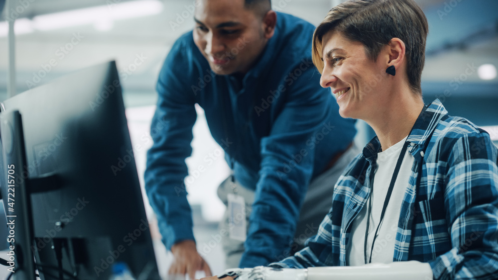 Aufkleber Teamwork In Diverse Office: Smiling Project Manager Talks with Happy Woman with Disability with Prosthetic Arm to Work on Computer. Professionals Create e-Commerce Software App.