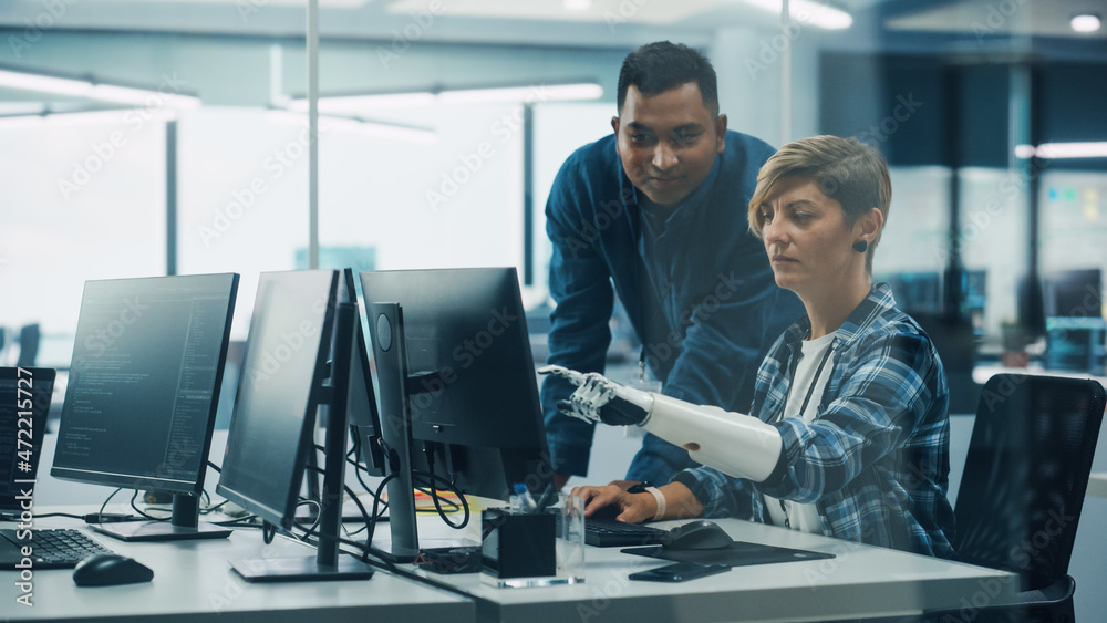 Aufkleber Teamwork In Diverse Inclusive Office: Project Manager Talks with Woman with Disability with Prosthetic Arm Work on Desktop Computer. Professionals Software Engineers Create e-Commerce App Solution