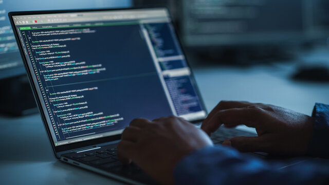 Close-up Focus on Person's Hands Typing on the Desktop Computer Keyboard. Screens Show Coding Language User Interface. Software Engineer Create Innovative e-Commerce App. Program Development