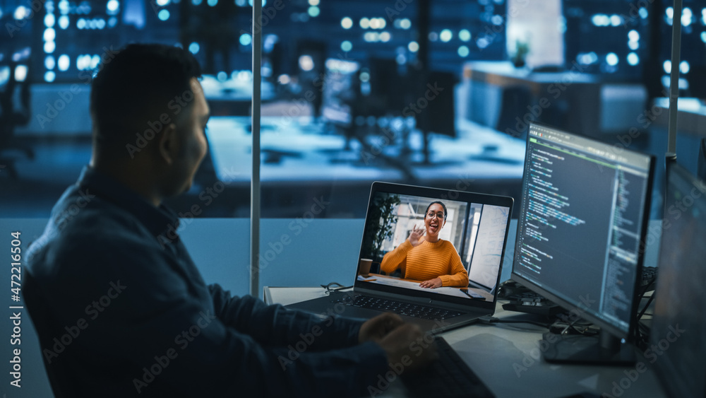 Poster remote teamwork in office at night: project manager talks with creative solutions specialist via vid