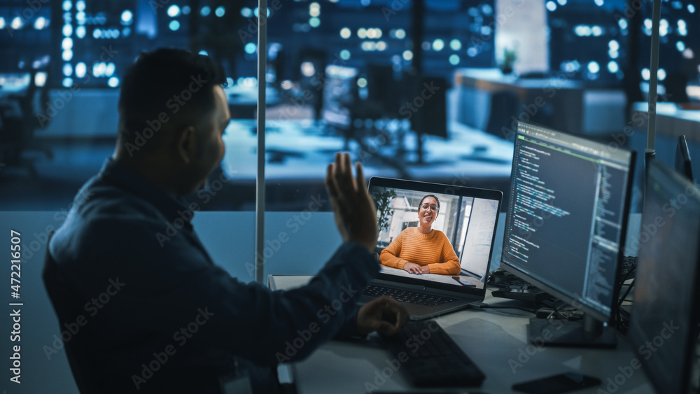 Poster remote teamwork in office at night: project manager talks with creative solutions specialist via vid