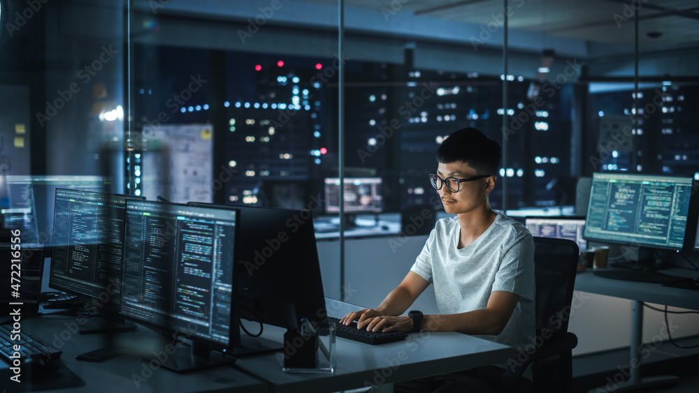 Poster night office: portrait of handsome japanese man in working on desktop computer. digital entrepreneur