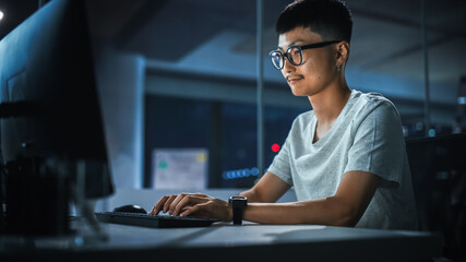 Night Office: Portrait of Handsome Japanese Man in Working on Desktop Computer. Digital...