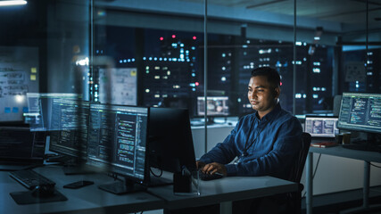 Night Office: Portrait of Handsome Indian Man in Working on Desktop Computer. Digital Entrepreneur Typing, Creating Modern Software, e-Commerce App Design, Programming. Stylish Authentic Person