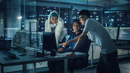 Diverse Team of Professionals Meeting in Office at Night: Brainstorming IT Programmers Use Computer...