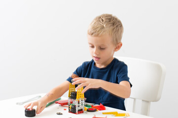 needlework, hand work
a little boy collects a children's designer from metal