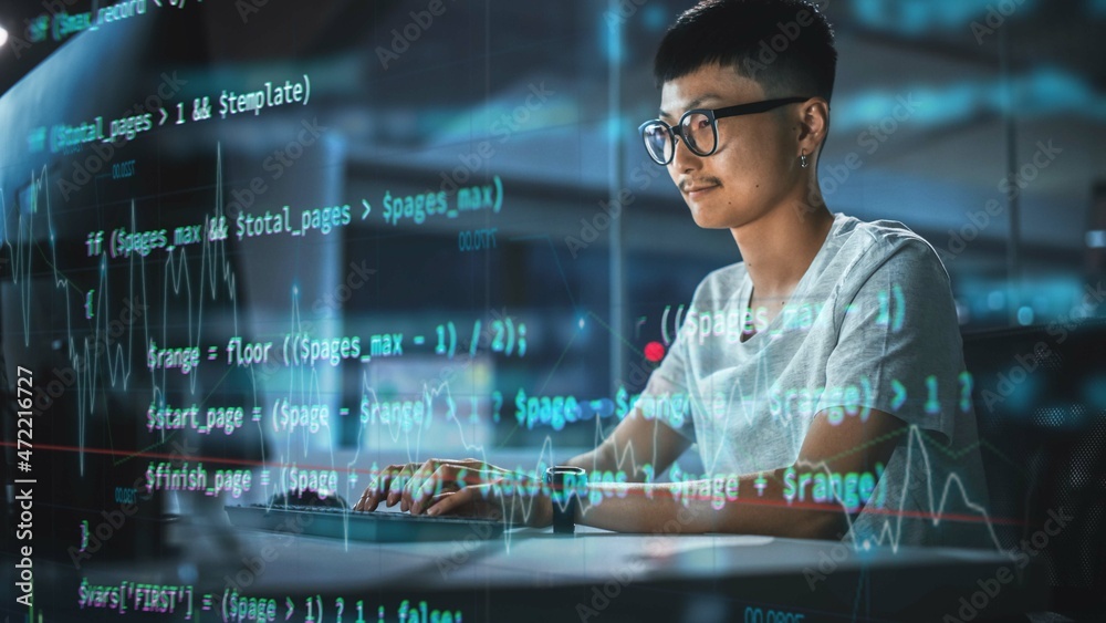 Leinwandbilder Shot with Visualisation of Running Script Code on Foreground. Young Japanese Man Working on Desktop Computer at Night Office. Digital Entrepreneur Creating Modern Software, e-Commerce App Design.