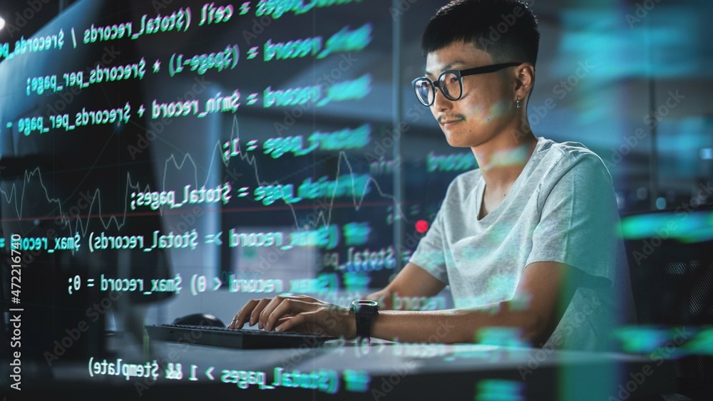 Aufkleber Shot with Visualisation of Running Script Code on Foreground. Young Japanese Man Working on Desktop Computer at Night Office. Digital Entrepreneur Creating Modern Software, e-Commerce App Design.