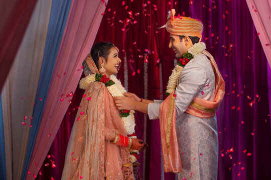 Couple performing Jaimala in mandap during their wedding