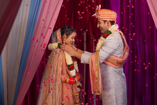 Couple performing Jaimala in mandap during their wedding