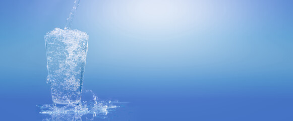 pouring water into a water glass isolated on blue background with copy space © winyu