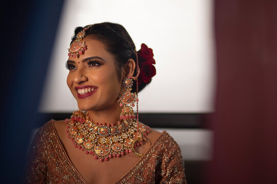Beautiful Indian bride in traditional wedding outfit smiling