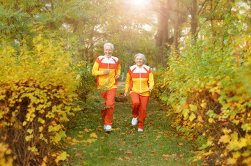 Portrait of happy fit senior couple jogging