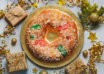 Roscon de reyes with cream and christmas ornaments. Kings day concept spanish three kings...