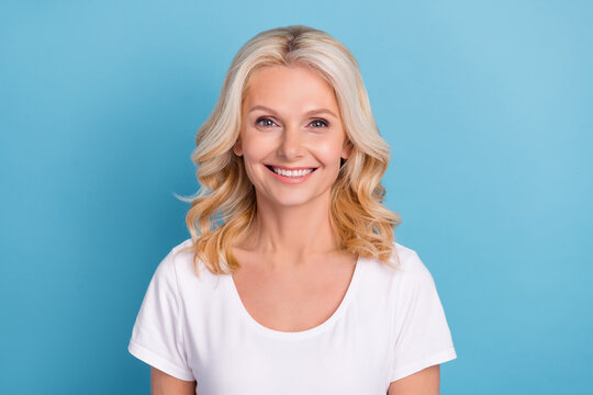 Photo of mature attractive woman happy positive toothy smile ceramic veneers clinic isolated over blue color background