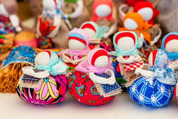 Russian traditional charm amulet doll on a showcase of handmaded souvenirs