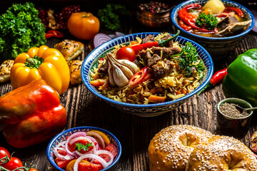 Uzbek and Central Asia cuisine concept. Assorted Uzbek food pilaf samsa lagman manti shurpa Uzbek restaurant concept Uzbek food. Food recipe background.