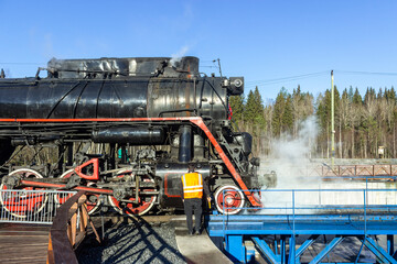 Russia, Karelia, Ruskeala, 08.09.2021. A steam locomotive in the Ruskeala Mountain Park and a turning circle for turning the locomotive in the opposite direction. editorial use only.