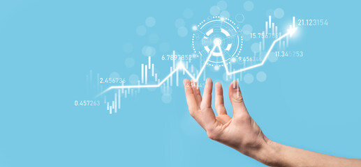 Businessman in hand hold banking business finance graph and invest in stock market investment point,economic growth and investor concept.analysis virtual stock market chart,analyze by use technology