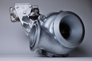 Close-up of an auto part for an internal combustion engine. Gas turbine. Turbo supercharger new on...