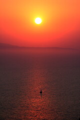 Sunset with lonely sailboat